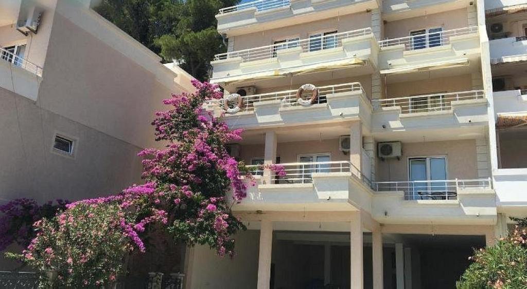 a building with flowers on the balconies of it at Nature View Vacation Flat in Ulcinj, Montenegro in Ulcinj