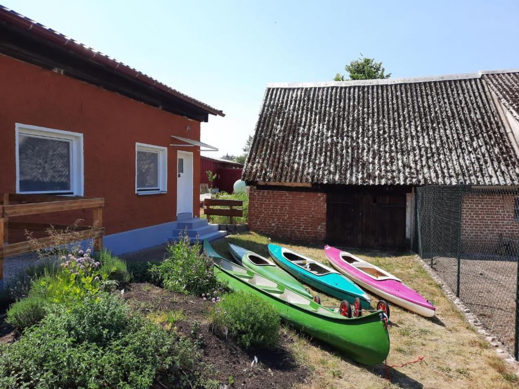 a group of boats sitting outside of a house at Apartment at the Vilzsee, Mirow in Diemitz