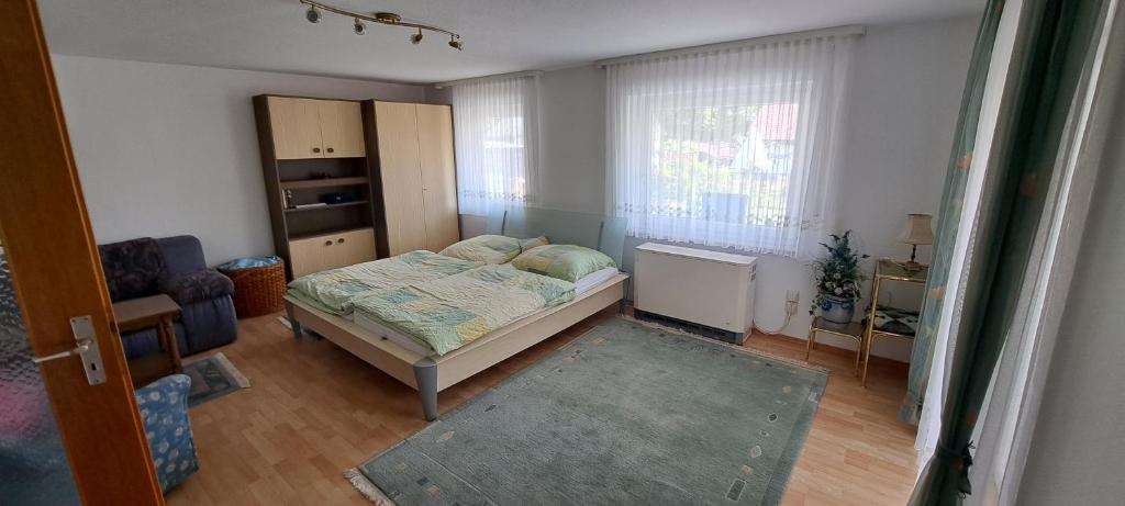 a small bedroom with a bed and a window at Retrowohnung in Oberndorf in Oberndorf