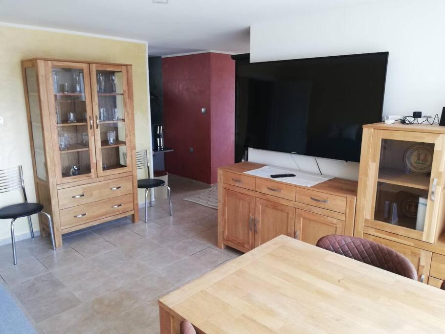 a living room with a large flat screen tv at Ferienwohnung mit Meerblick! in Sveti Vlas
