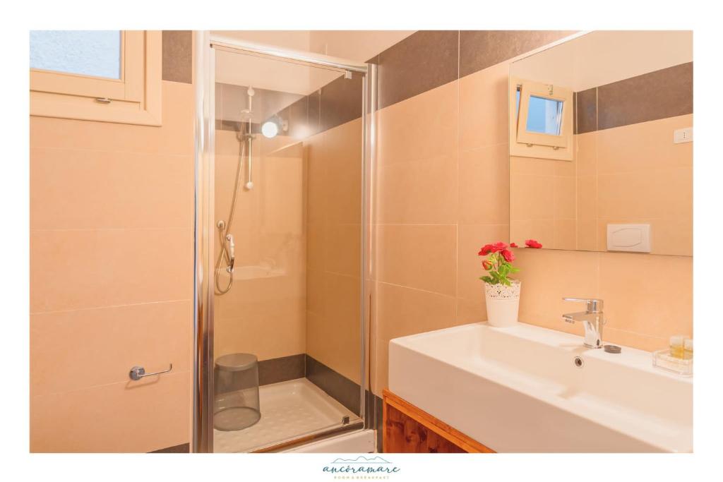 a bathroom with a shower and a sink at Ancóramare in Stintino