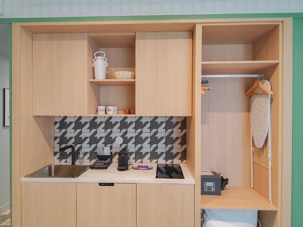 a kitchen with a sink and a counter top at Aparthotel AMMI Nice Lafayette in Nice