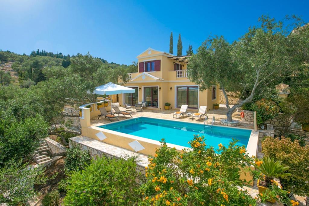 a villa with a swimming pool and a house at Triena Quality Villas in Gaios