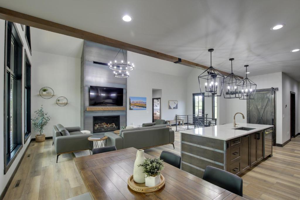 a kitchen and living room with a table and chairs at Luxurious Lead Vacation Rental with Private Hot Tub! in Lead