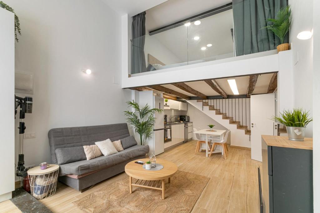 a living room with a couch and a table at Nice Central Loft in Vilanova i la Geltrú