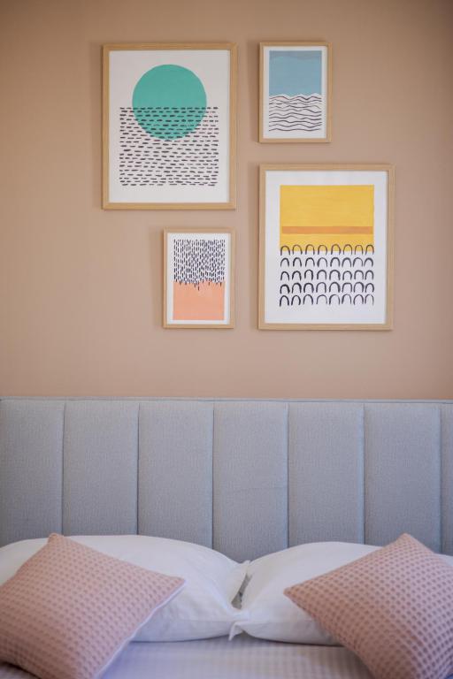 a bedroom with a bed with three pictures on the wall at Luxury Rooms Zara&Ane in Split