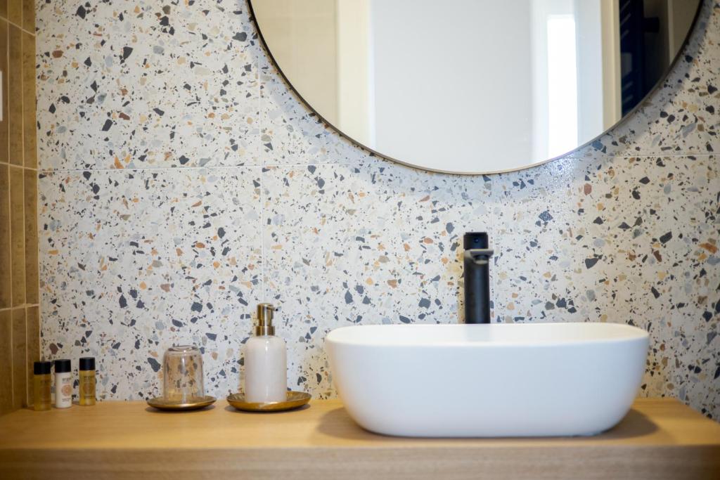 a bathroom with a white sink and a mirror at Luxury Rooms Zara&Ane in Split