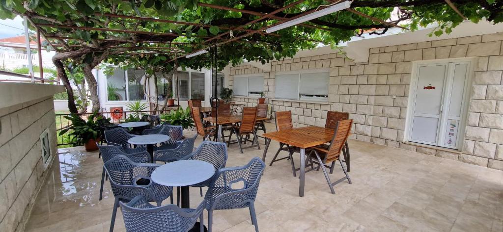a group of tables and chairs in a patio at Palute in Supetar