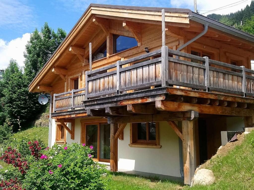 a wooden house with a balcony on the side of it at Chalet Arêches-Beaufort, 4 pièces, 8 personnes - FR-1-342-208 in Beaufort