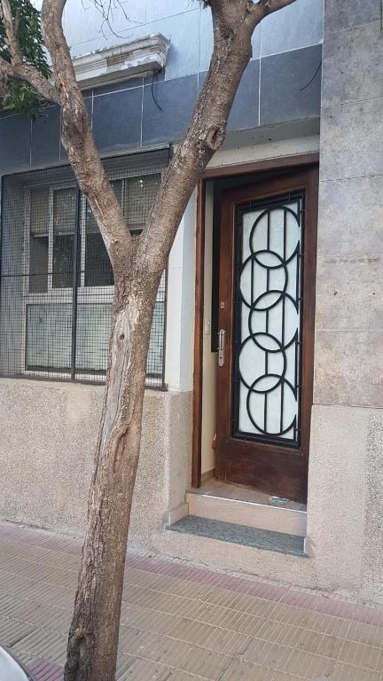 a door of a building with a tree in front of it at Apart B in San Luis