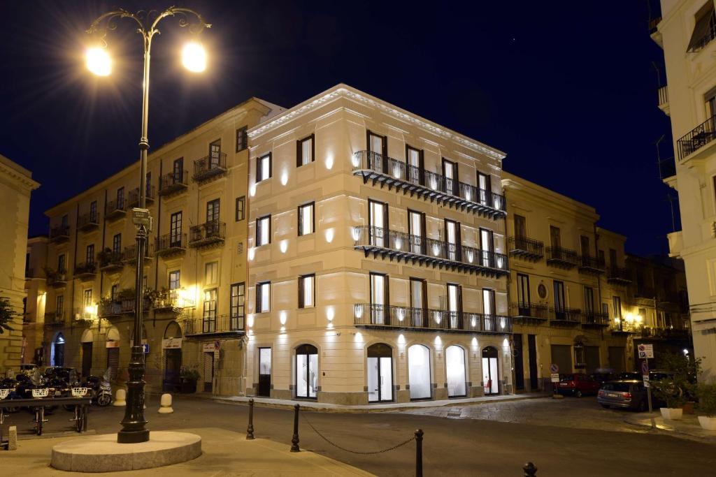 a large white building with lights on it at night at Best Western Hotel Principe di Lampedusa in Palermo
