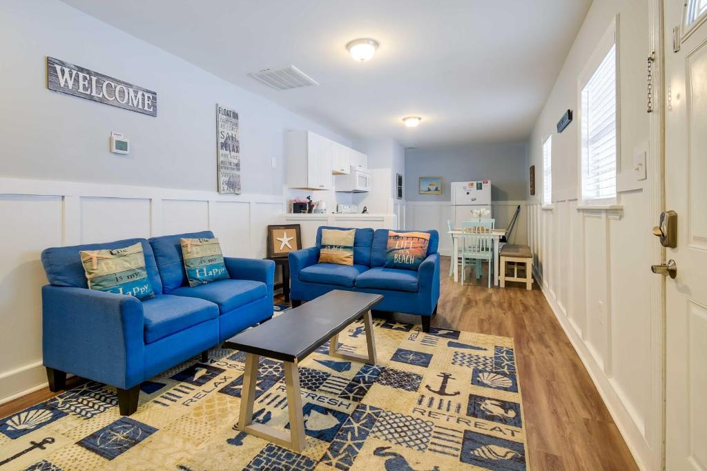 a living room with two blue couches and a table at 2 Mi to Barefoot Landing! Baileys Beach Cottage in Myrtle Beach