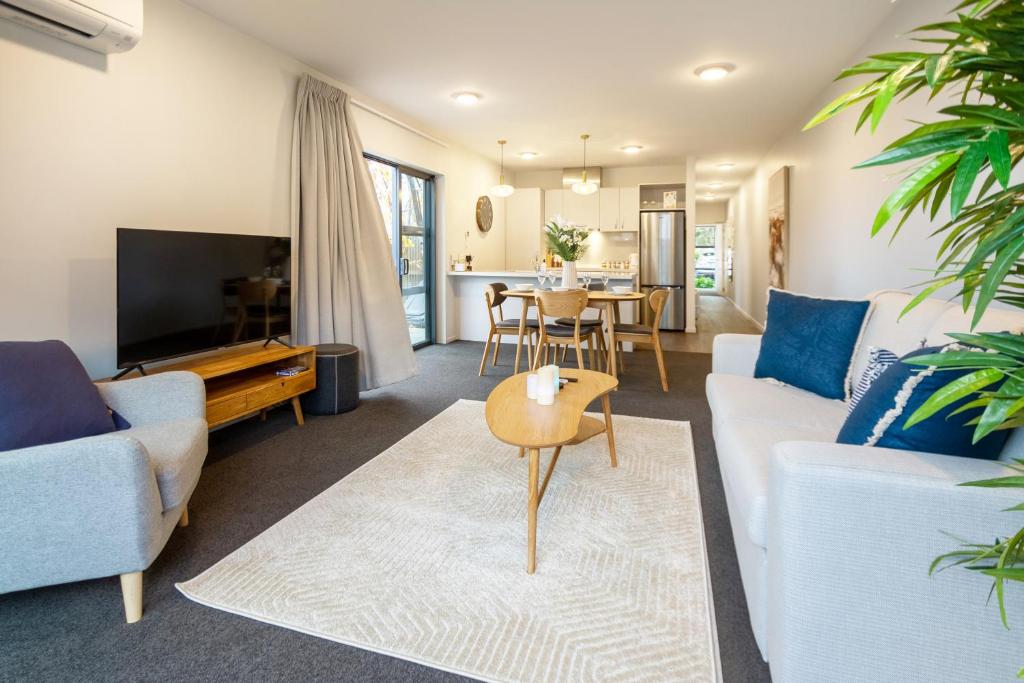 a living room with a couch and a table at Luxurious Christchurch Suite - Single Level 2 bed in Christchurch