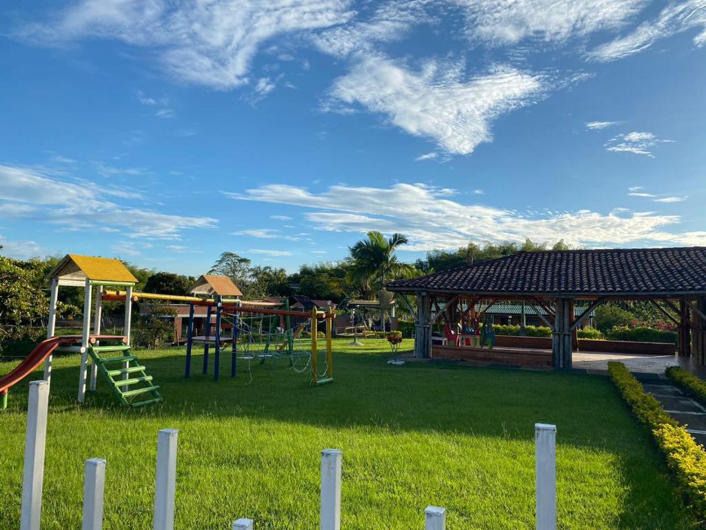 a park with a playground with a slide at Drora glamping in Pereira