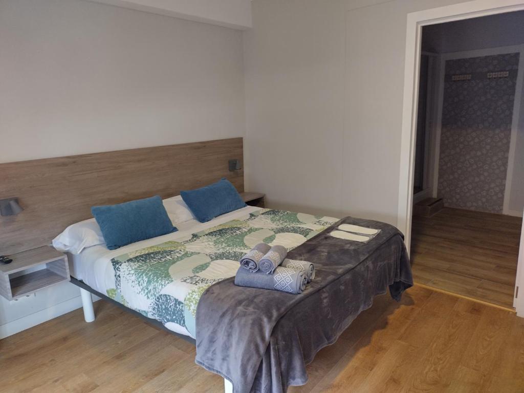 ein Schlafzimmer mit einem Bett mit zwei Handtüchern darauf in der Unterkunft Pensión Casa Douro in Santiago de Compostela
