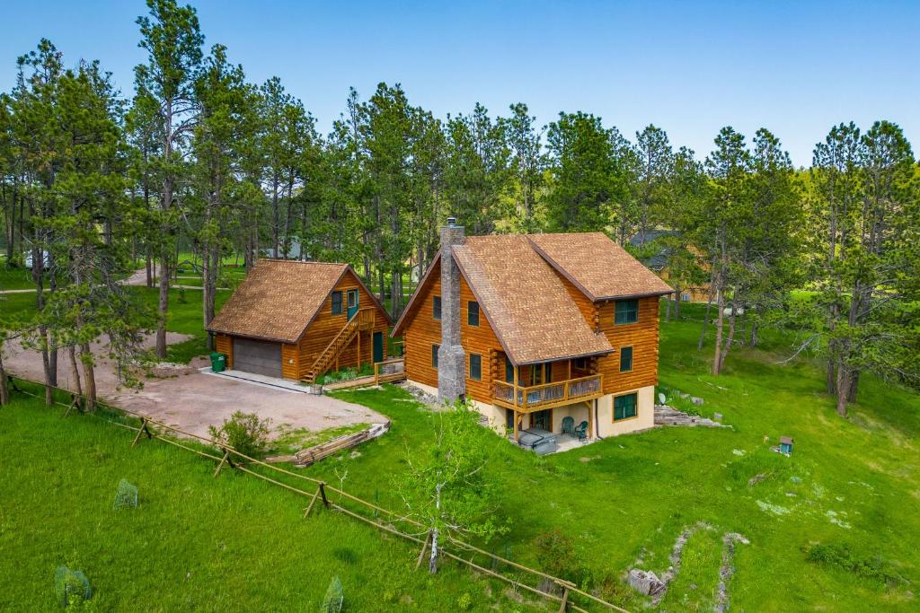 an aerial view of a log cabin in the woods at Tranquility on White Tail Road in Deadwood