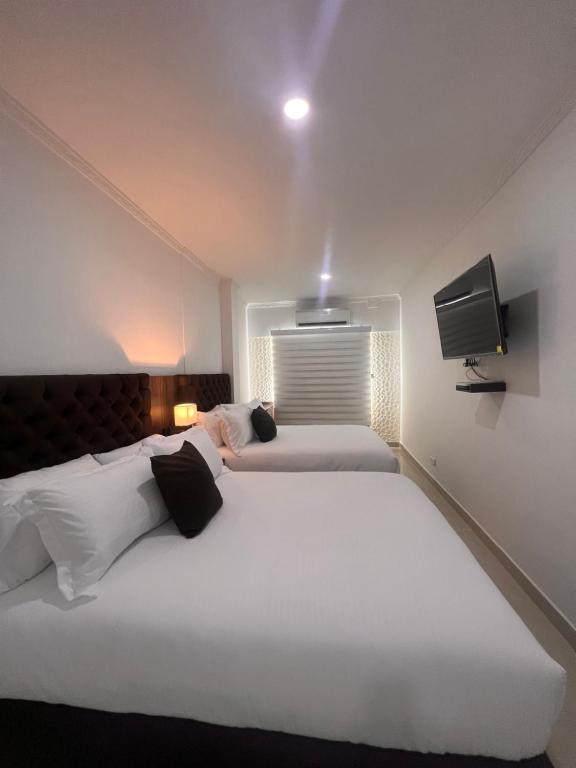 Postel nebo postele na pokoji v ubytování Hotel Zuriel Boutique
