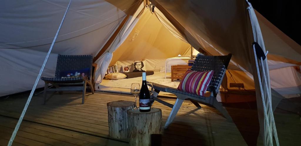 A bed or beds in a room at Base Glamp Bruny - Heated Tents for 8 People