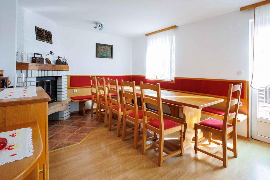 a dining room with a wooden table and chairs at Holiday home in Adlesici - Dolenjska & Bela krajina Unter- & Weißkrain 44970 in Adlešiči