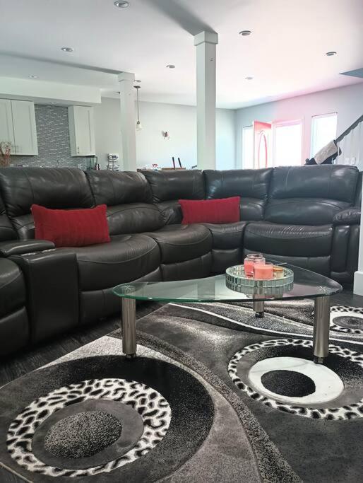 a living room with a black couch and a table at Nice & Near Downtown Nashville in Nashville