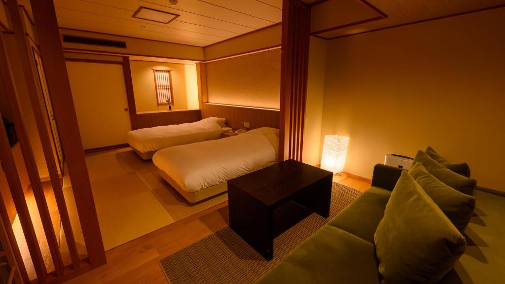 Postel nebo postele na pokoji v ubytování Tamaya Ryokan