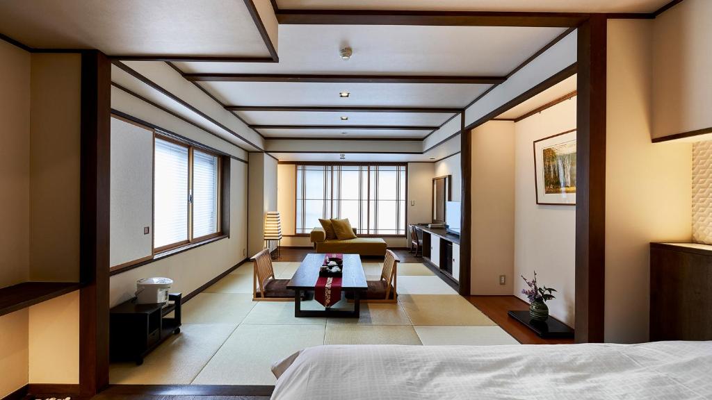 Postel nebo postele na pokoji v ubytování Tamaya Ryokan