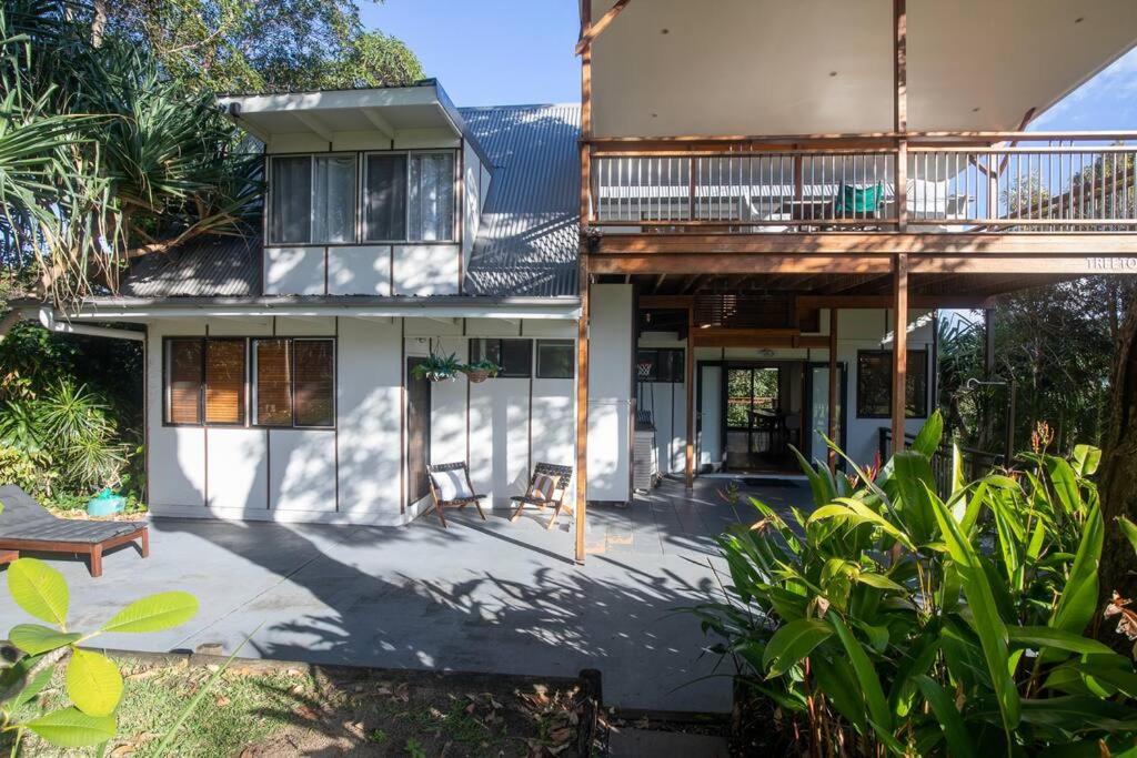 a house with a balcony and a patio at 20 Yarrong Road Close to Cylinder Beach in Point Lookout