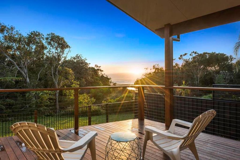 two chairs and a table on a deck with a view at Del Boca Vista in Emerald Beach