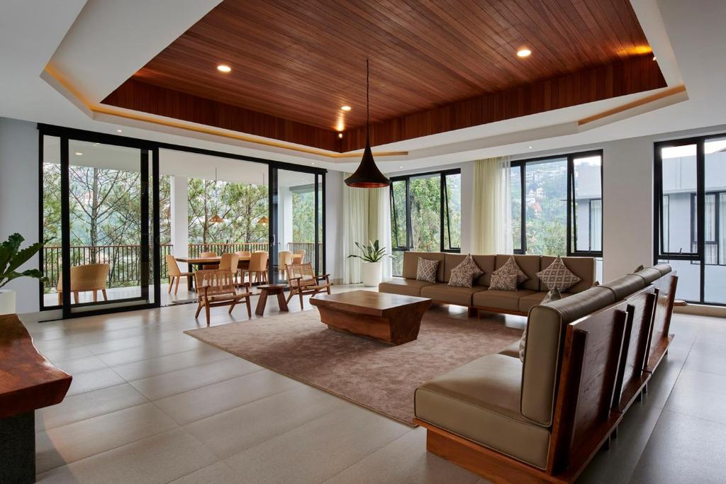 a living room with a couch and a table at Atsuka Hill View Villa 8 bedrooms with a private heated swimming pool in Bandung