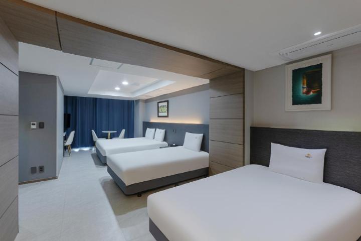 Postel nebo postele na pokoji v ubytování Sun Cloud Hotel