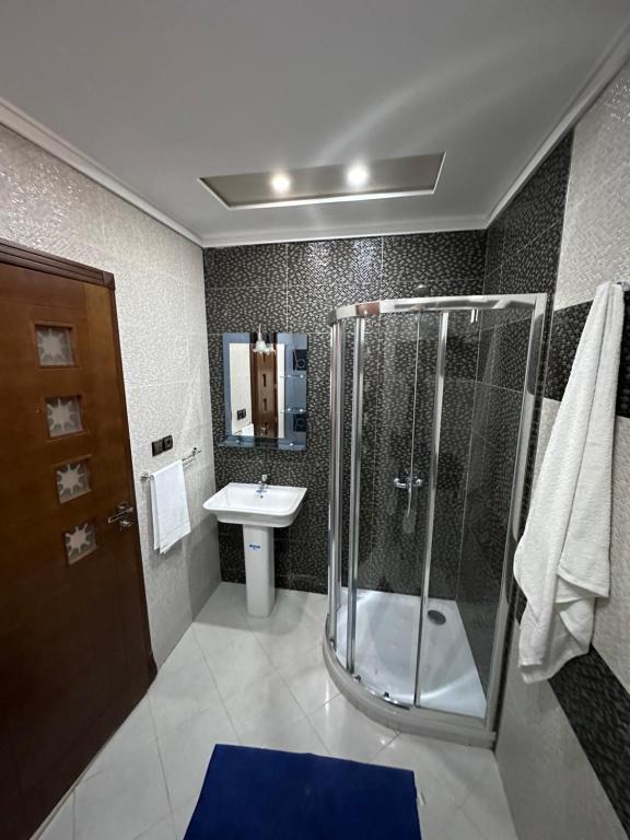 a bathroom with a shower and a sink at Abraj Dubai Larache in Larache
