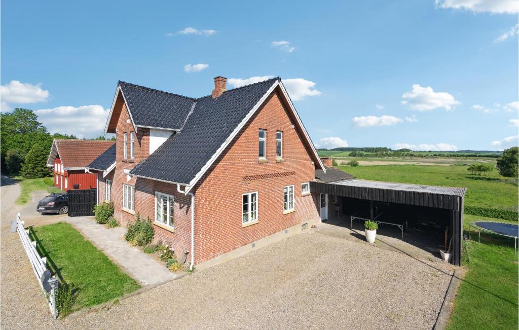 a large brick house with a garage at Nice Home In Christiansfeld With House Sea View in Christiansfeld