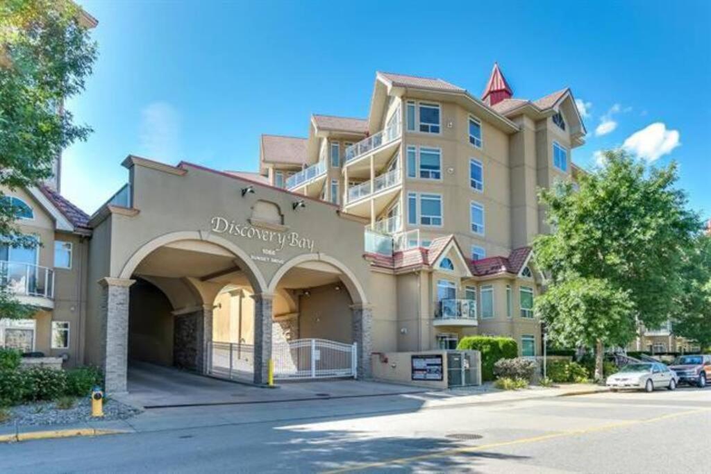 a large apartment building with a parking lot at Downtown Kelowna 2 Bdrm 2 Bath Waterfront Condo in Kelowna
