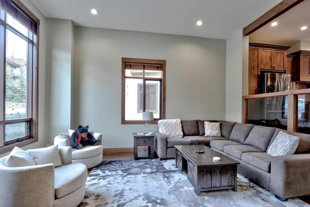a living room with two couches and a coffee table at Village Walk #21 By Bear Country in Sun Peaks