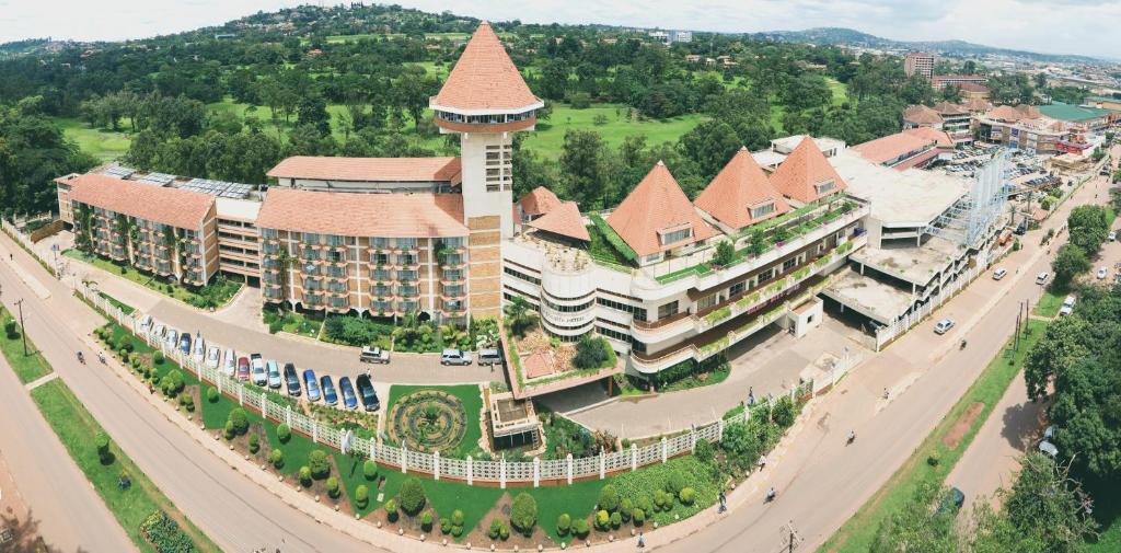 an aerial view of a large building with a tower at Golf Course Hotel in Kampala