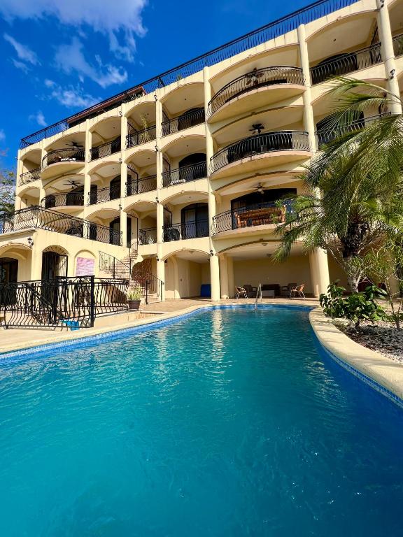 a hotel with a swimming pool in front of a building at Oceanview Rancho with Two bedroom & Two baths in Coco