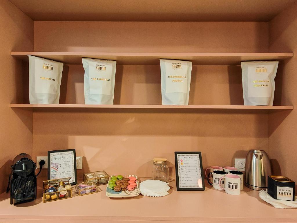 a shelf with food and items on it at Aparthotel AMMI Nice Lafayette in Nice