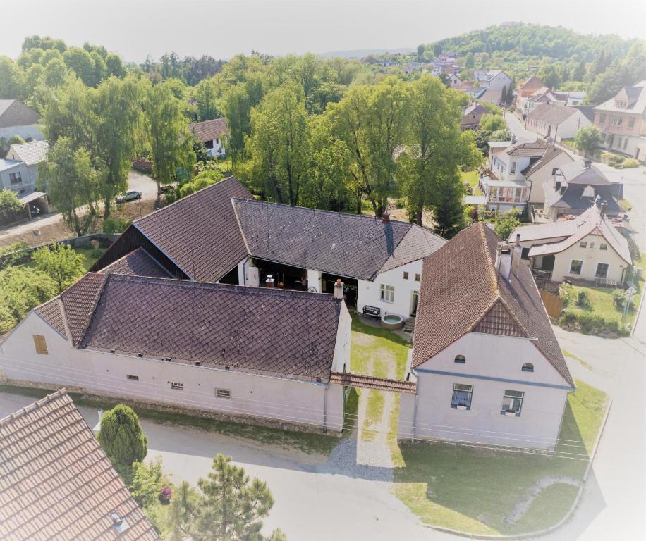 an aerial view of a white house with brown roofs at Historic Farmhouse Kojetice in Kojetice