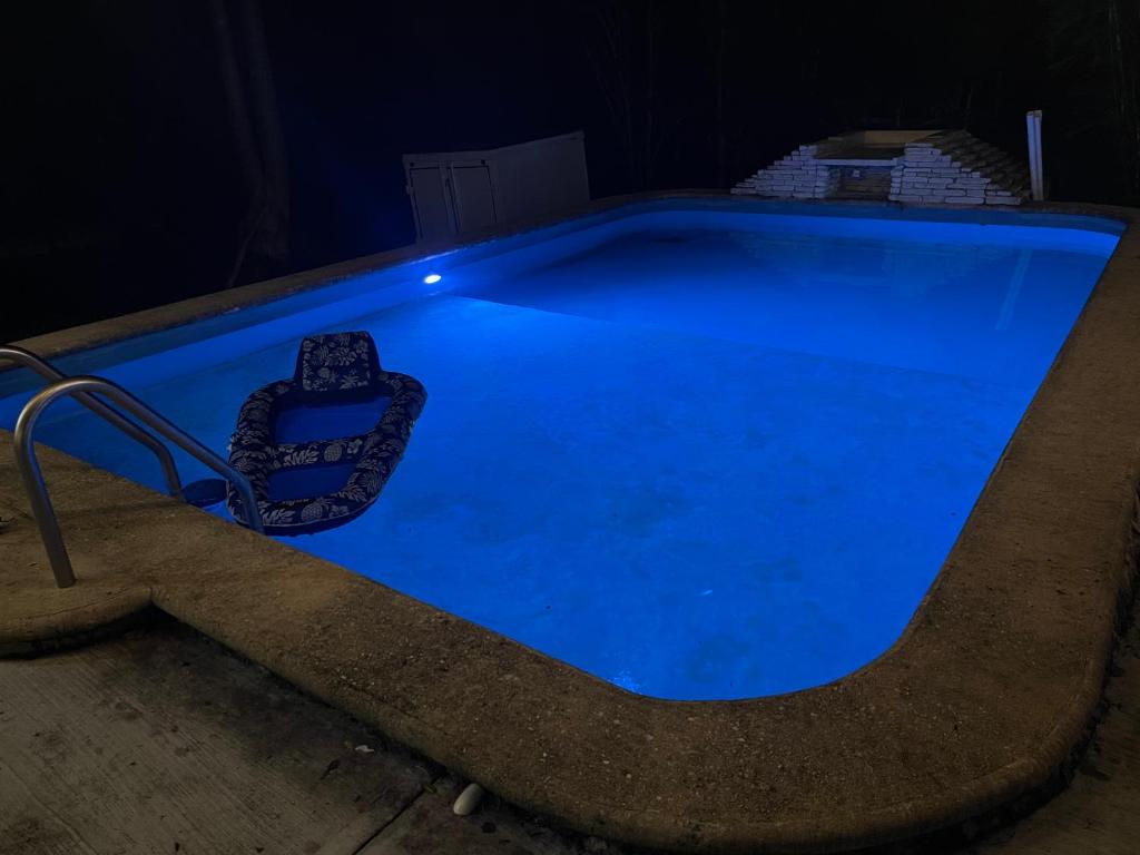 a swimming pool lit up at night at 1 bedroom home with pool/patio in a Mayan village. in Cuncunul
