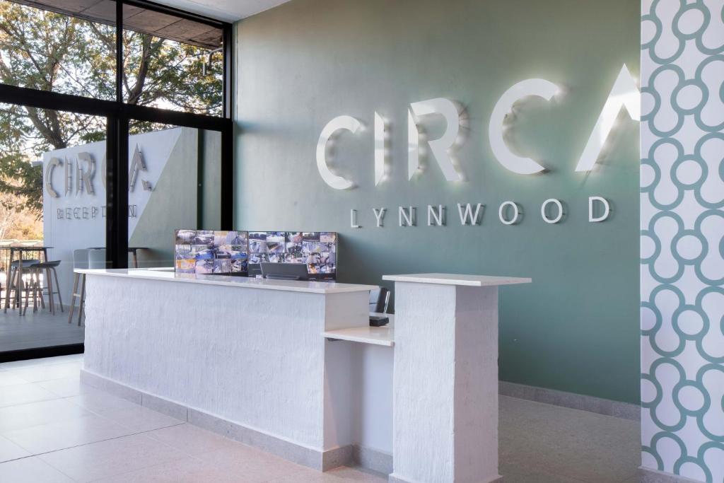 a counter in a store with a sign on the wall at Circa Aparthotel by Totalstay in Pretoria