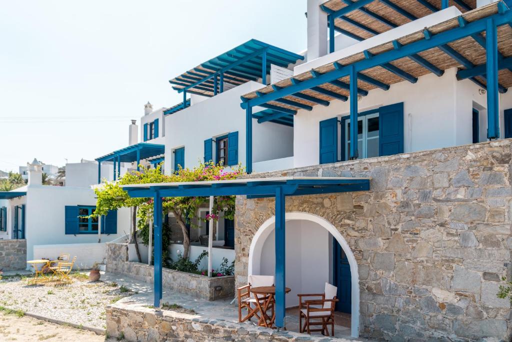 a house with blue beams and a stone wall at Niel Serifos in Serifos Chora