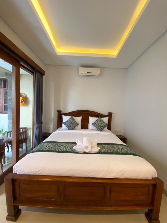 Postel nebo postele na pokoji v ubytování Kope House Ubud
