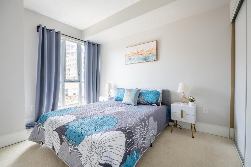 a bedroom with a bed and a window at Beautiful Condos In the Heart of Downtown by GLOBALSTAY in Toronto