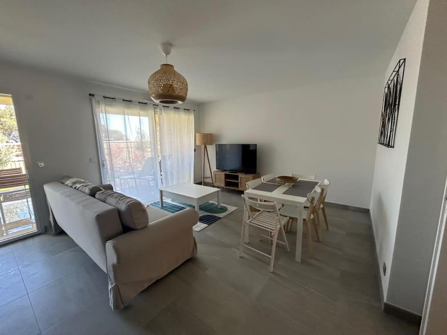 a living room with a couch and a table at Prestige View 103 in Èze