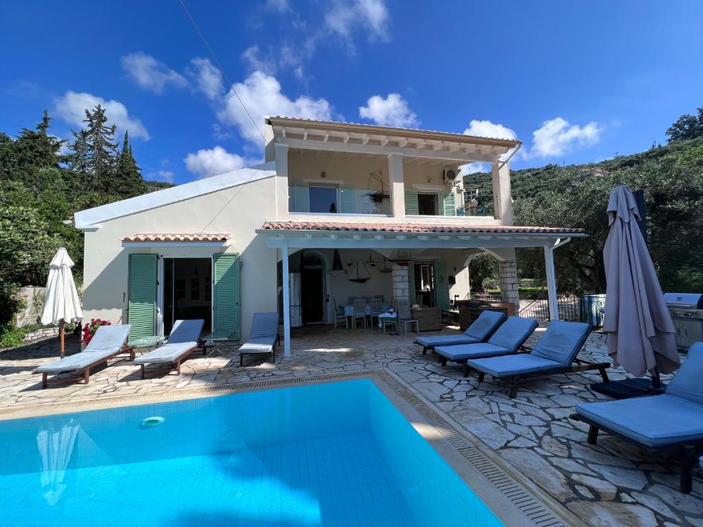 a villa with a swimming pool and a house at Villa Rex - A little piece of heaven! in Nisakion