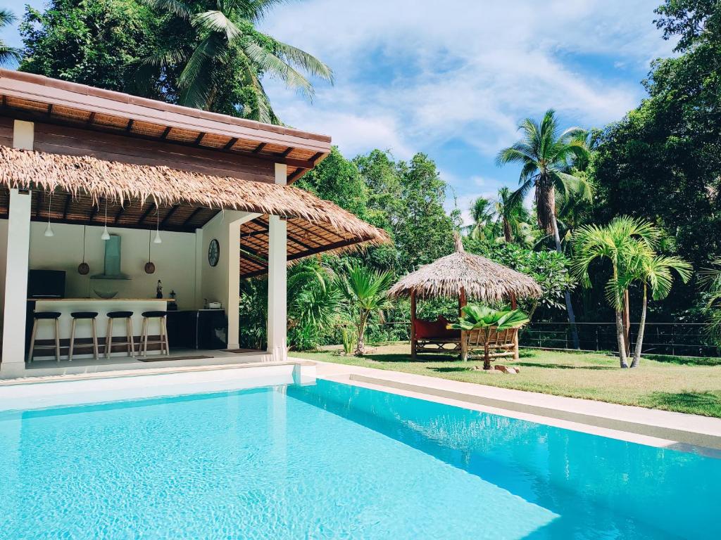 a villa with a swimming pool and a pavilion at Superb pool villa 5 bedrooms in Baan Tai