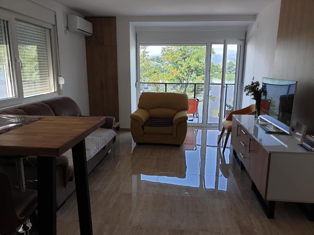 a living room with a couch and a chair and a table at Apartman 3 BMB in Veliko Gradište