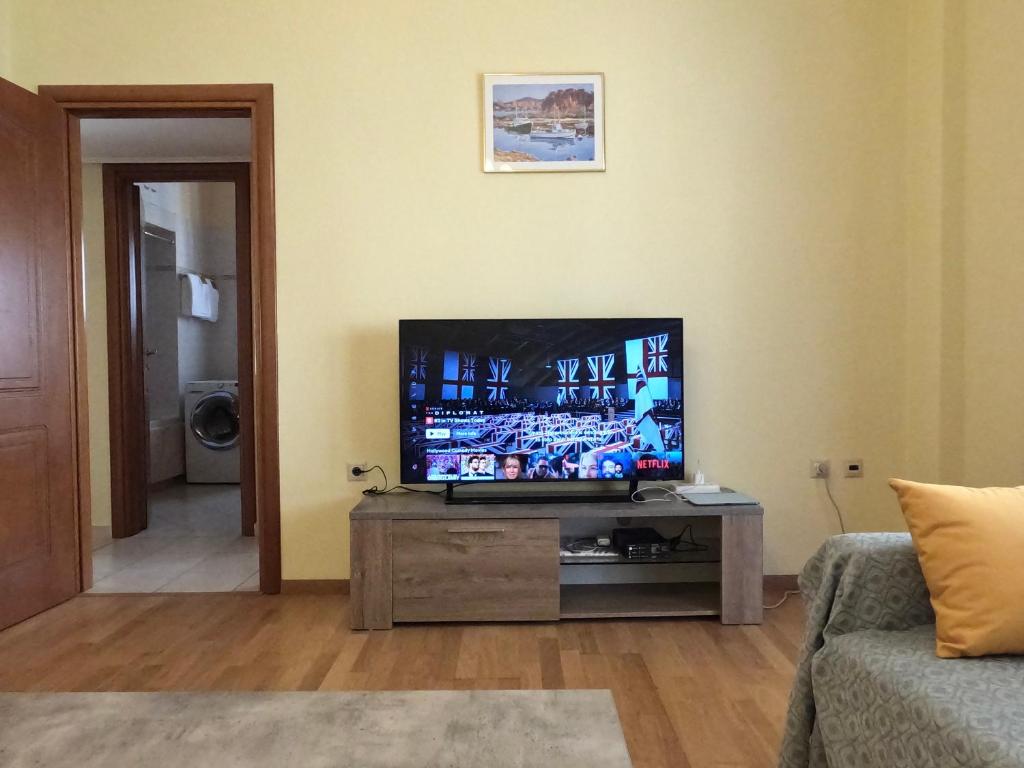 a living room with a flat screen tv on a table at Big Apt 3bed 3bath 10 min walk Acropolis in Athens