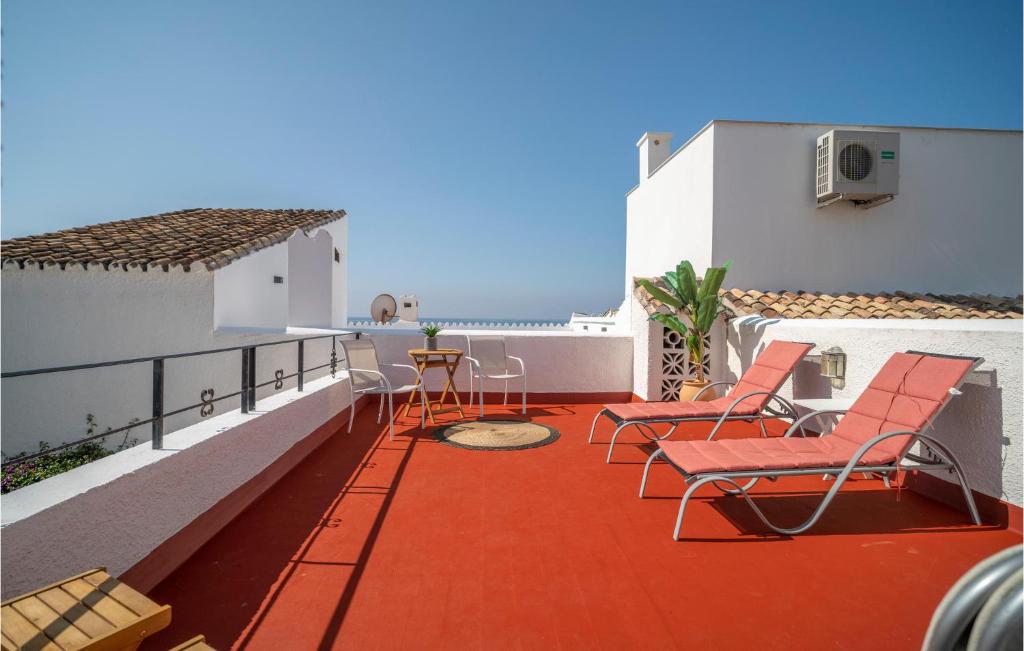 a balcony with chairs and a view of the ocean at Gorgeous Home In Estepona With Kitchen in Estepona