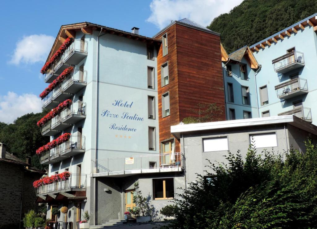 a building with a sign on the side of it at Residence Pizzo Scalino in Chiesa in Valmalenco